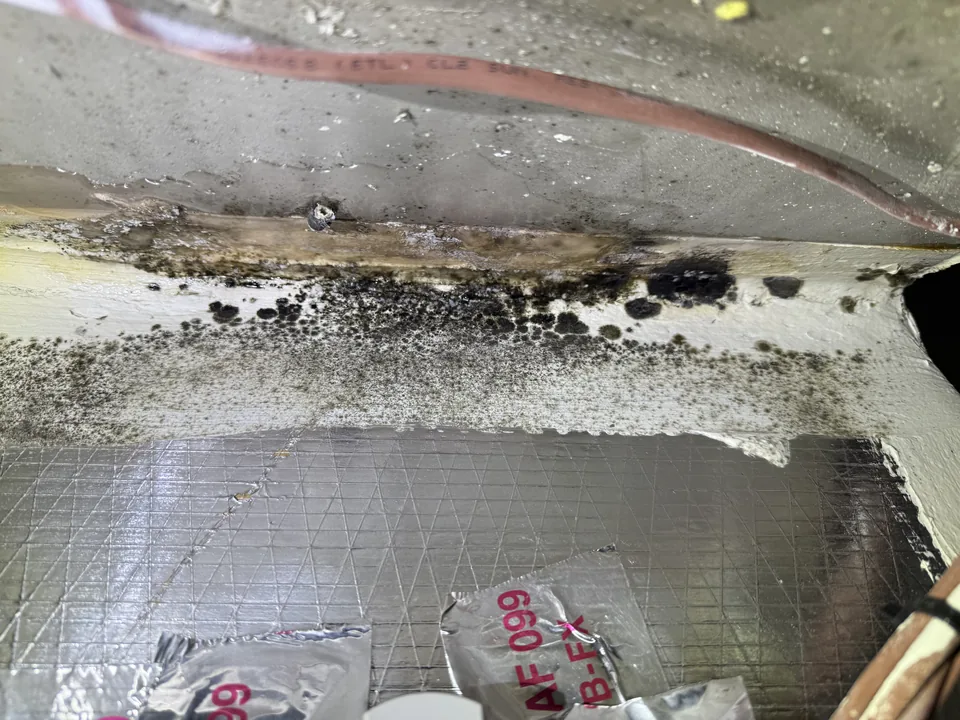 Mold growth along a supply plenum seam, attributed to condensation during a PureSpec HVAC evaluation